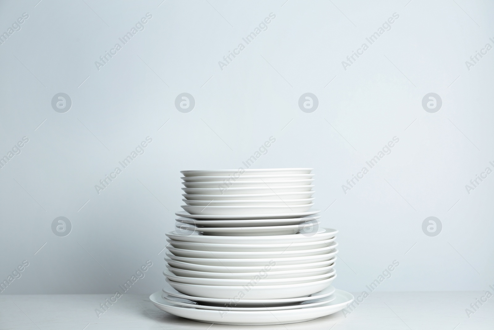 Photo of Stack of clean plates on white background