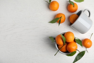 Flat lay composition with fresh ripe tangerines and space for text on wooden background