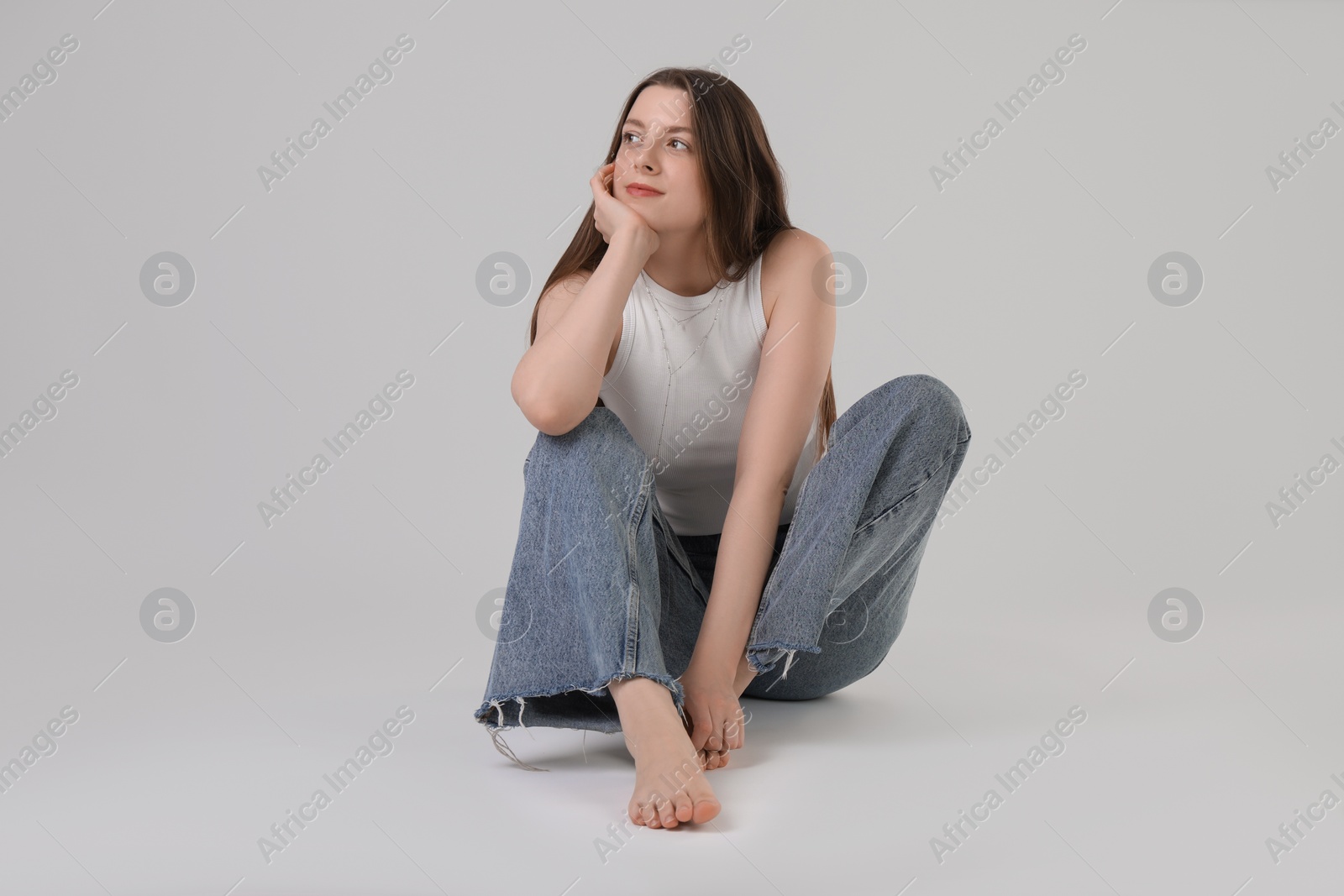 Photo of Portrait of beautiful young woman on light grey background