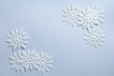 Beautiful snowflakes on white background, flat lay. Space for text