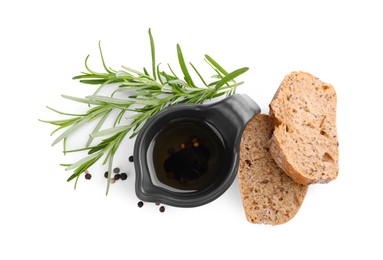 Photo of Saucepan of organic balsamic vinegar with oil, spices and bread slices isolated on white, top view