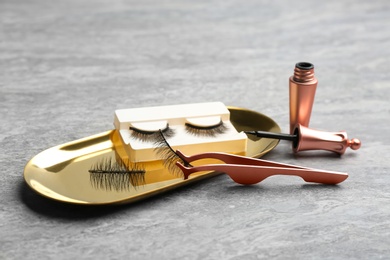 Magnetic eyelashes and accessories on grey table