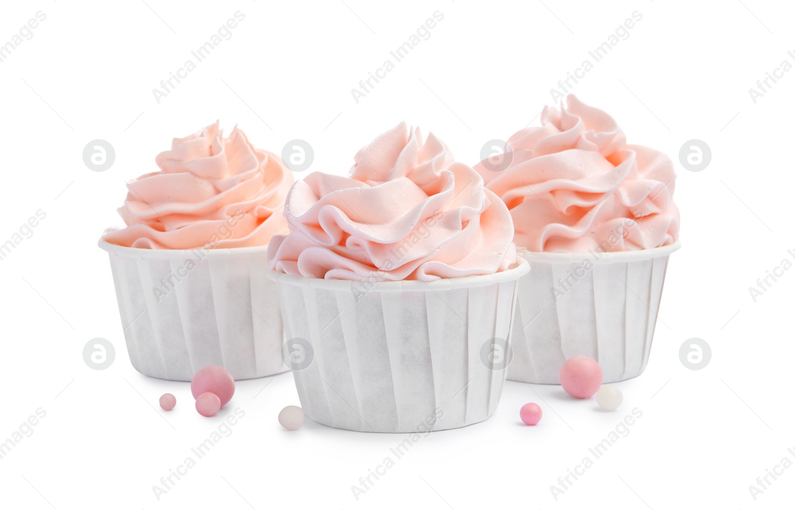 Photo of Tasty cupcakes with cream and sprinkles isolated on white