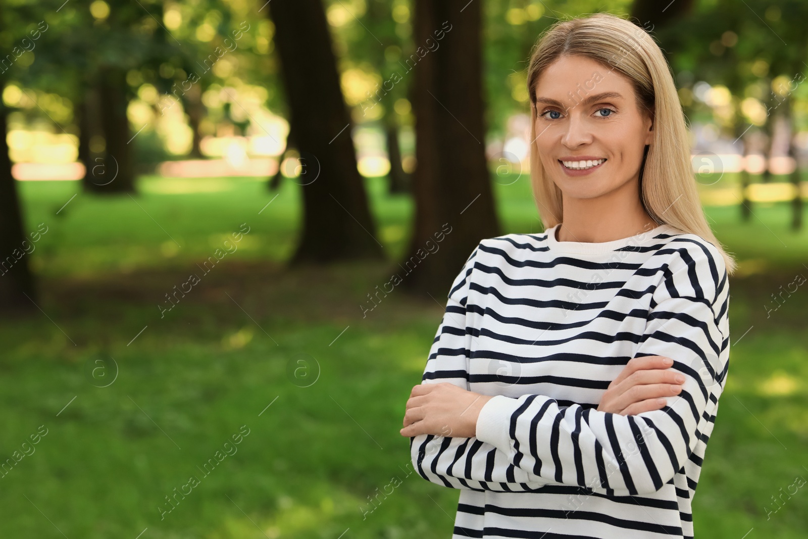 Photo of Portrait of happy woman in casual clothes outdoors. Space for text. Attractive lady smiling and posing for camera