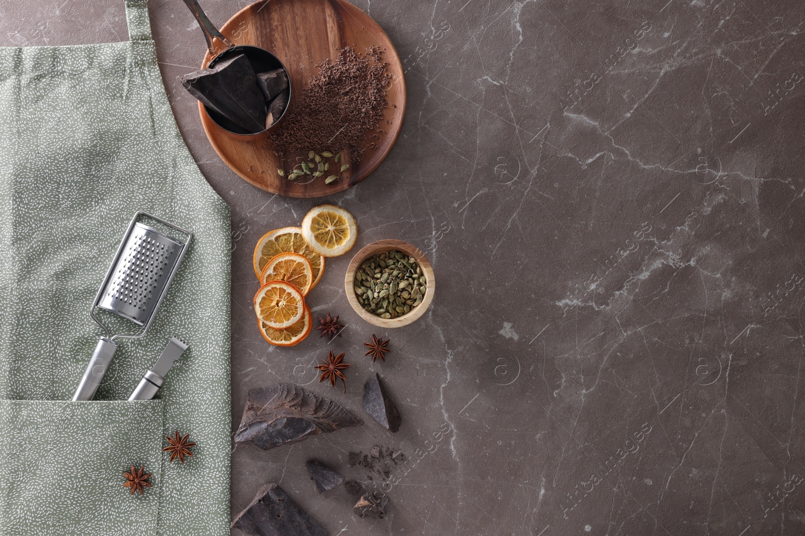 Photo of Clean apron with kitchen tools and different ingredients on brown marble table, flat lay. Space for text