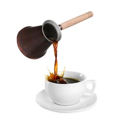 Pouring freshly brewed aromatic coffee from turkish pot into cup. Objects in air on white background