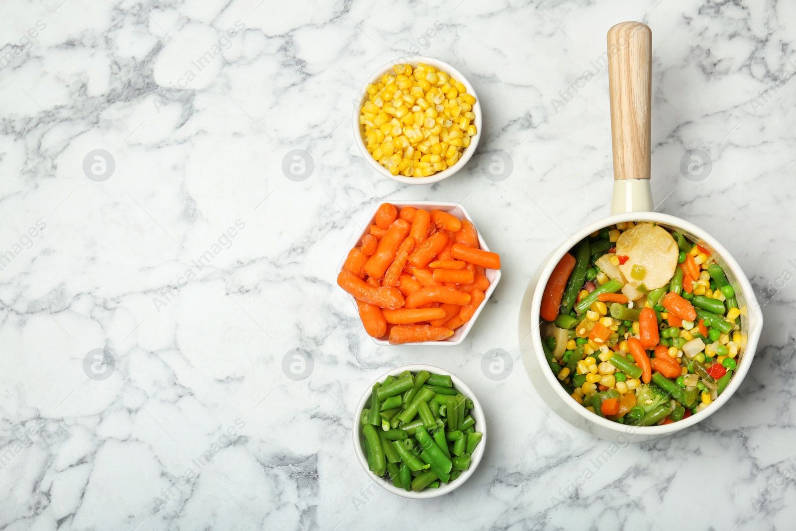 Photo of Flat lay composition with frozen vegetables on marble background