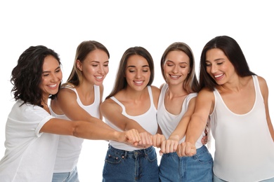 Happy women putting hands together on white background. Girl power concept