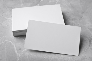 Photo of Stack of empty sheets on grey marble table. Mock up for design