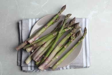 Fresh raw asparagus on light grey marble table, flat lay