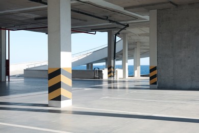 Empty open car parking near sea on sunny day