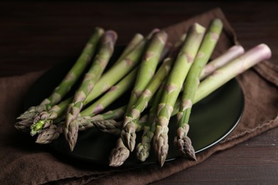 Fresh raw asparagus on wooden table, closeup