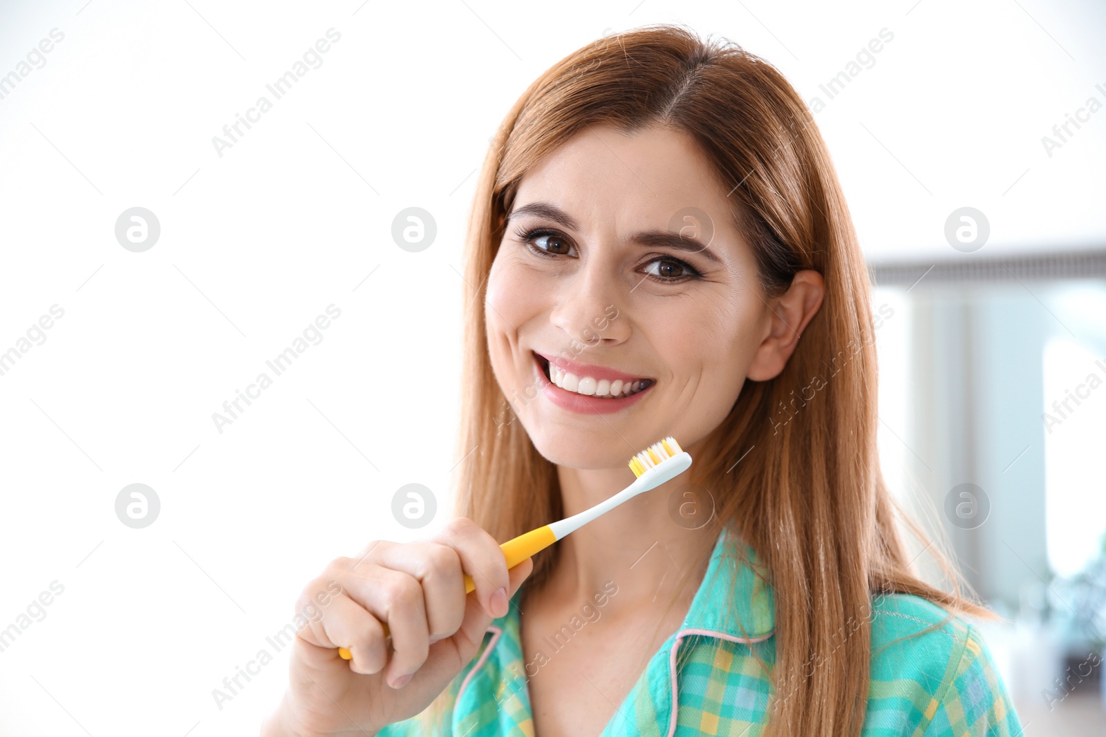 Photo of Portrait of woman with toothbrush in bathroom. Personal hygiene