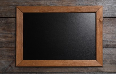 Photo of Blank chalkboard on wooden background, top view. Space for text