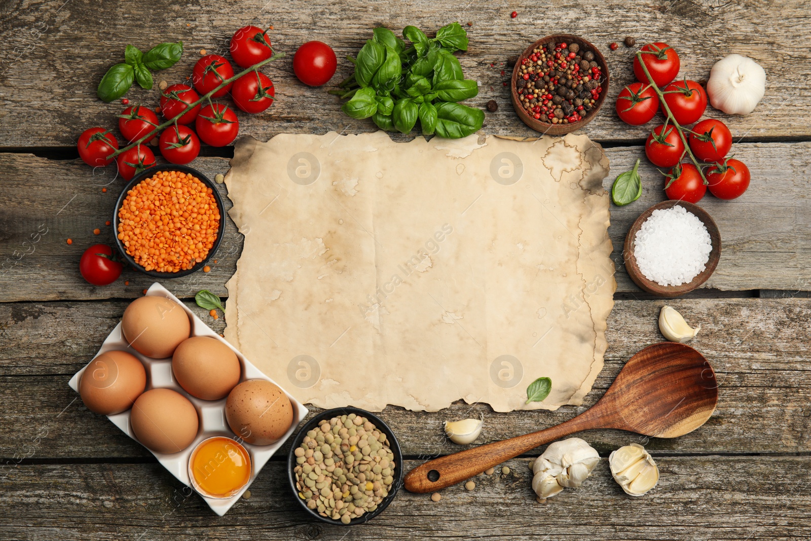 Photo of Parchment surrounded by different ingredients on wooden table, flat lay with space for text. Cooking classes