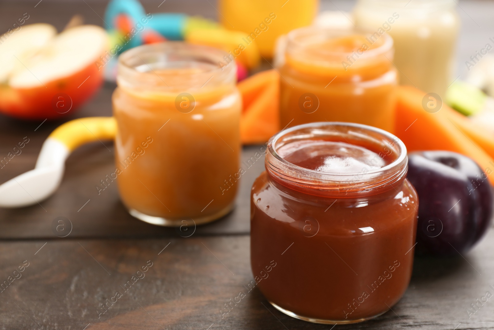 Photo of Jars with healthy baby food on table