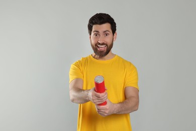 Photo of Emotional man with party popper on light grey background