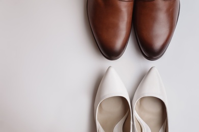 Photo of Wedding shoes for bride and groom on white background, top view