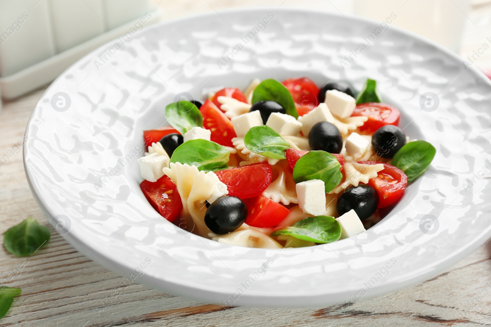 Photo of Plate with delicious pasta primavera on table