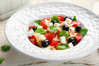 Plate with delicious pasta primavera on table