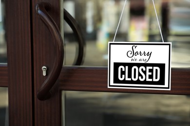 Image of Sorry we are closed sign hanging on glass door