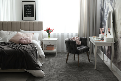 Photo of Stylish bedroom interior with elegant dressing table and floral wallpaper