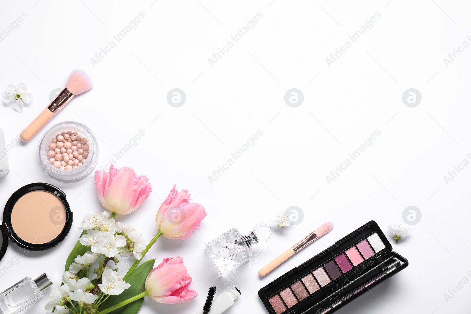 Photo of Flat lay composition with different makeup products and beautiful spring flowers on white background, space for text