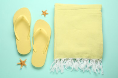 Flat lay composition with different beach objects on light blue background