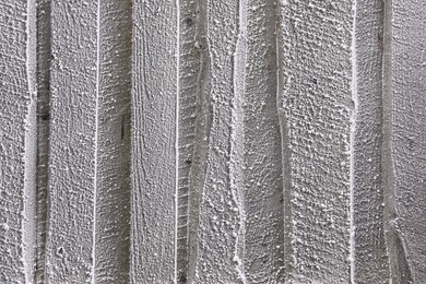 Photo of Wooden wall covered with hoarfrost on snowy day, closeup