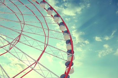 Image of Beautiful large Ferris wheel outdoors, low angle view, space for text