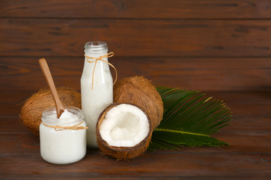 Composition with organic coconut oil on wooden table. Healthy cooking