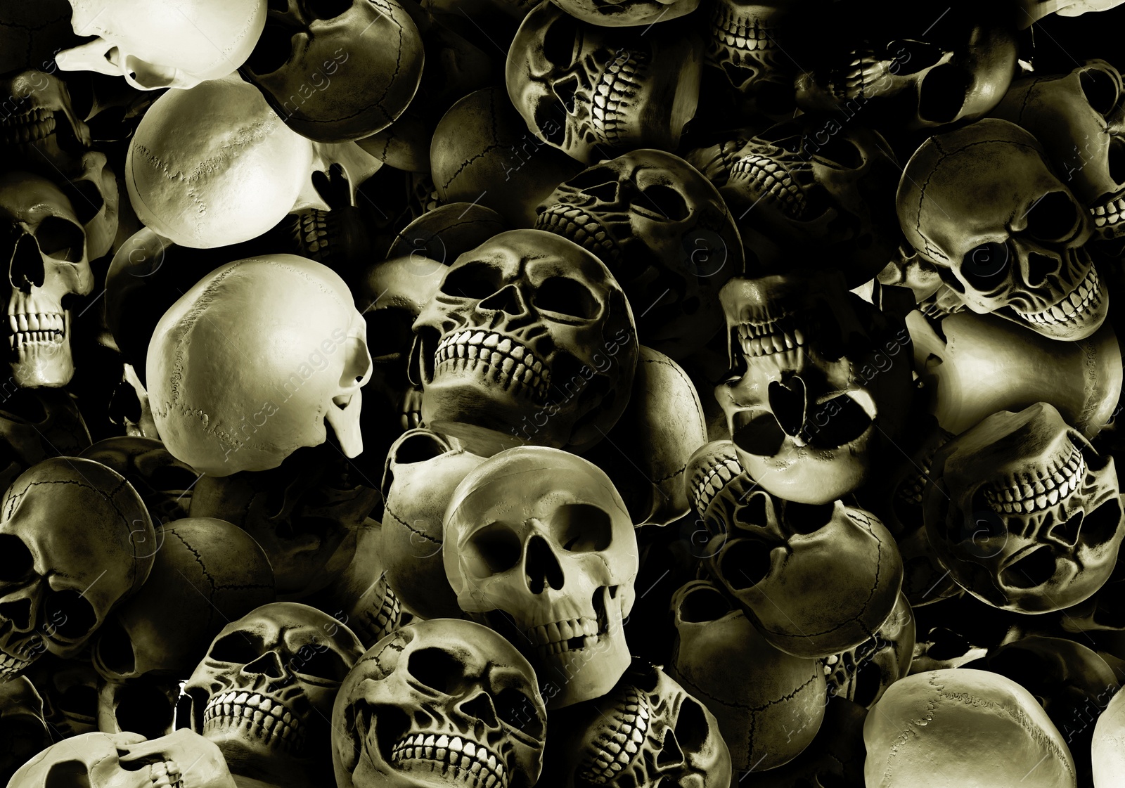 Image of Many scary human skulls as background. Collage design