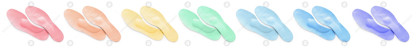 Image of Set with colorful orthopedic insoles on white background, top view. Banner design