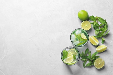 Photo of Flat lay composition with refreshing lime beverage and ingredients on light background