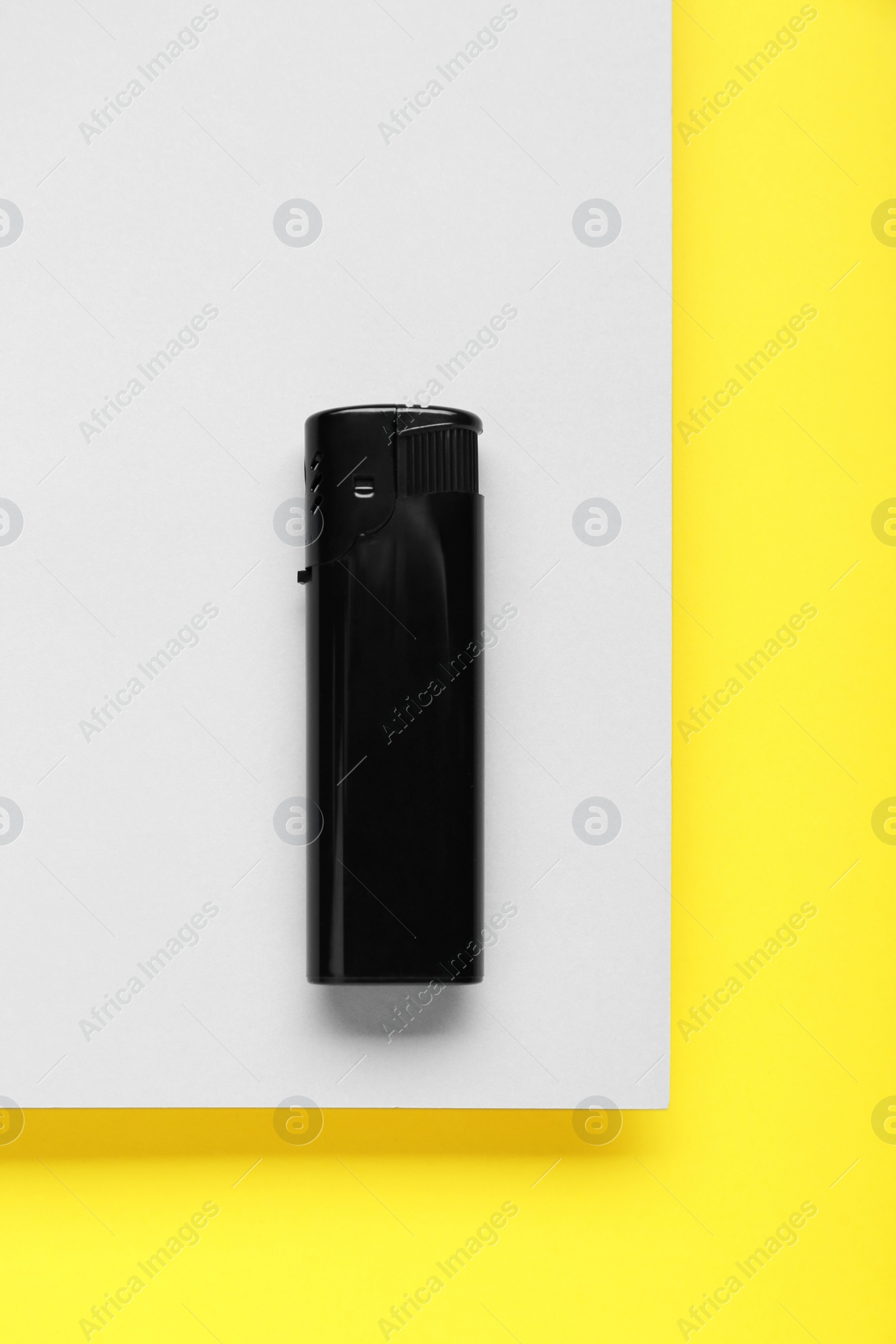 Photo of Stylish small pocket lighter on color background, top view