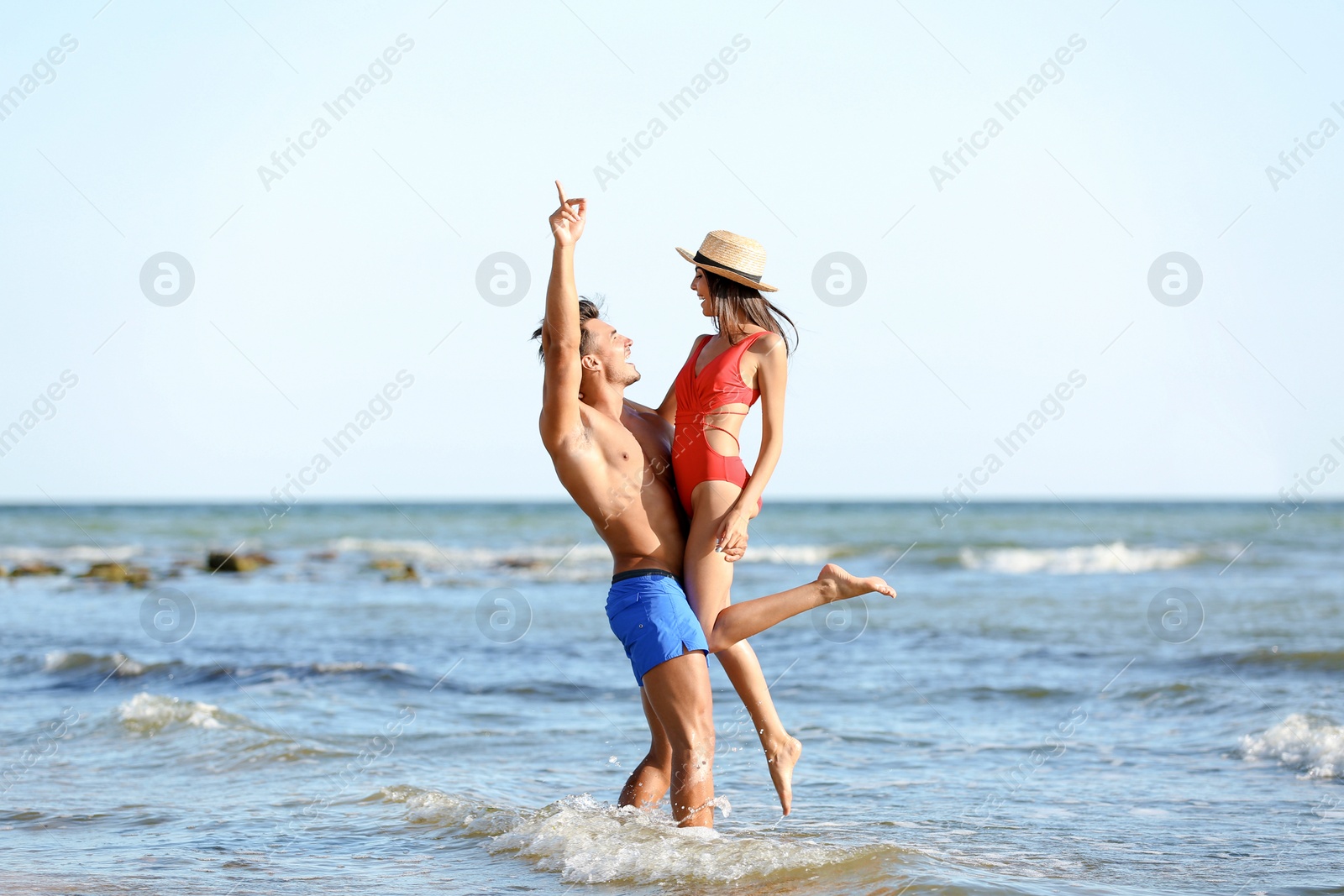 Photo of Happy young couple having fun at beach on sunny day