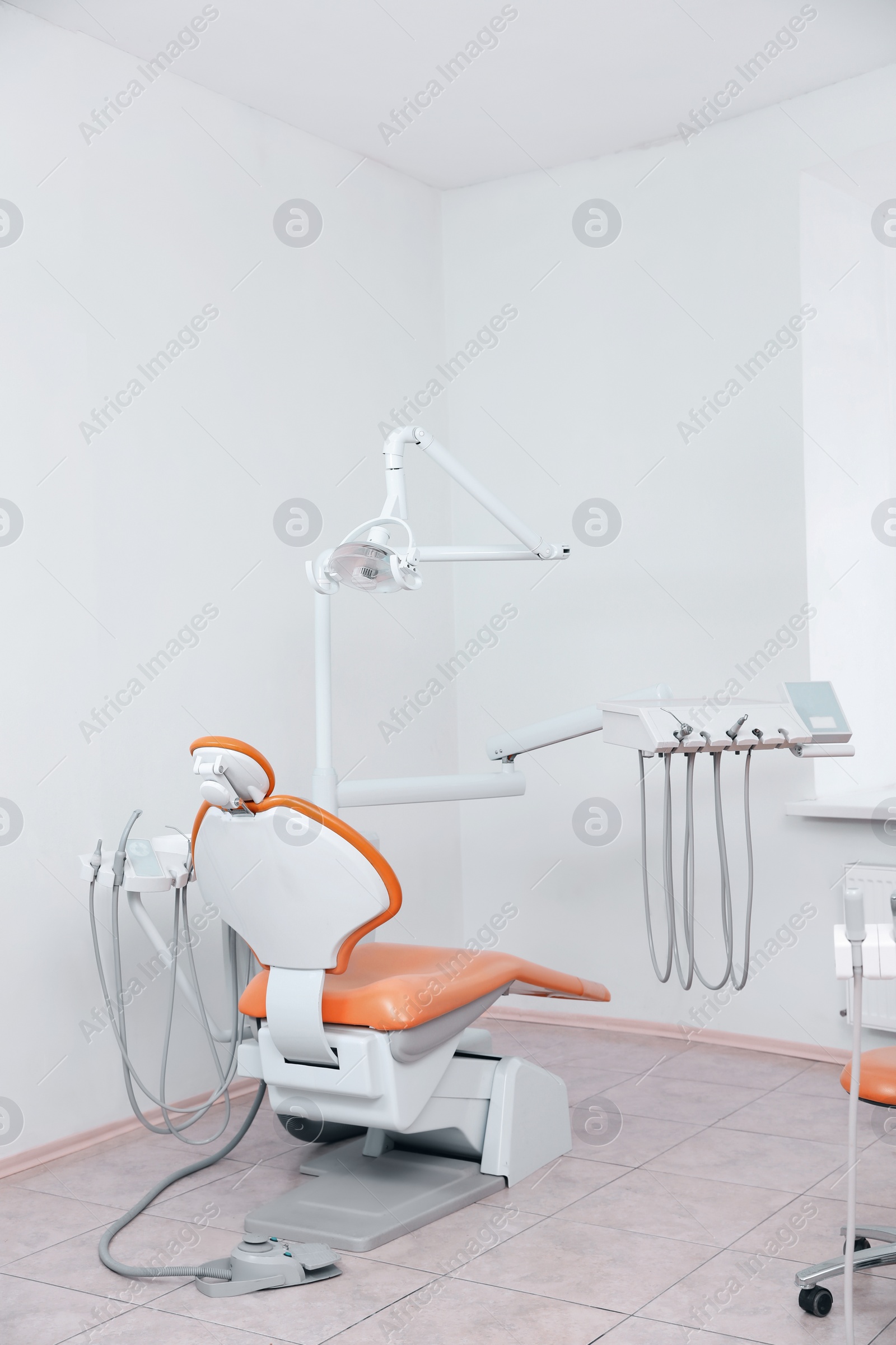 Photo of Dentist's office with modern chair and professional equipment