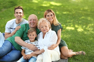 Photo of Couple with son and elderly parents in park