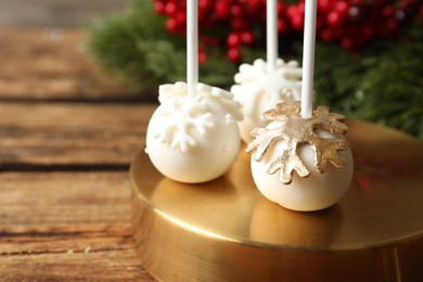 Delicious Christmas ball cake pops on wooden table, closeup