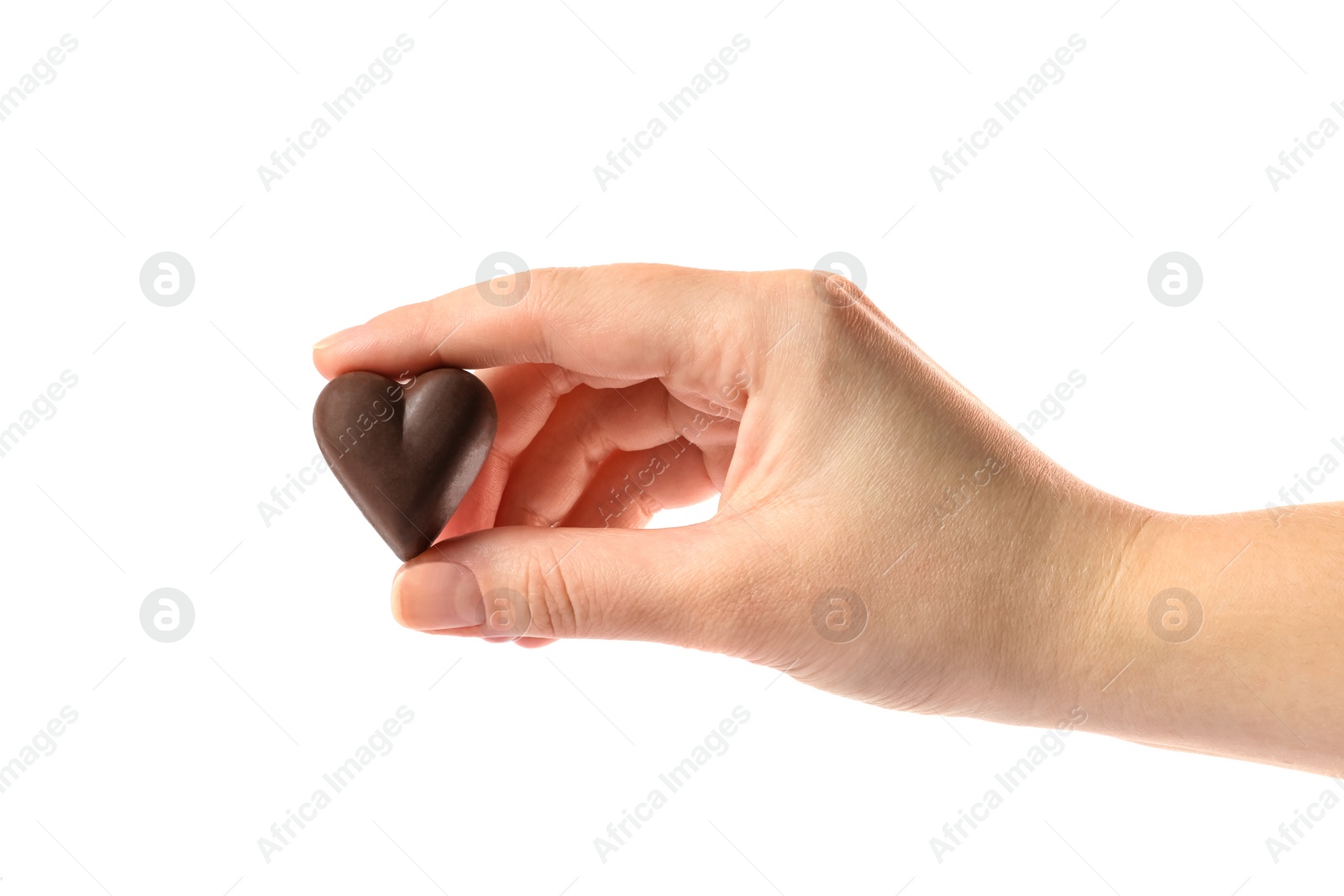 Photo of Woman holding heart shaped chocolate candy on white background, closeup