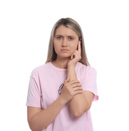 Young woman suffering from ear pain on white background