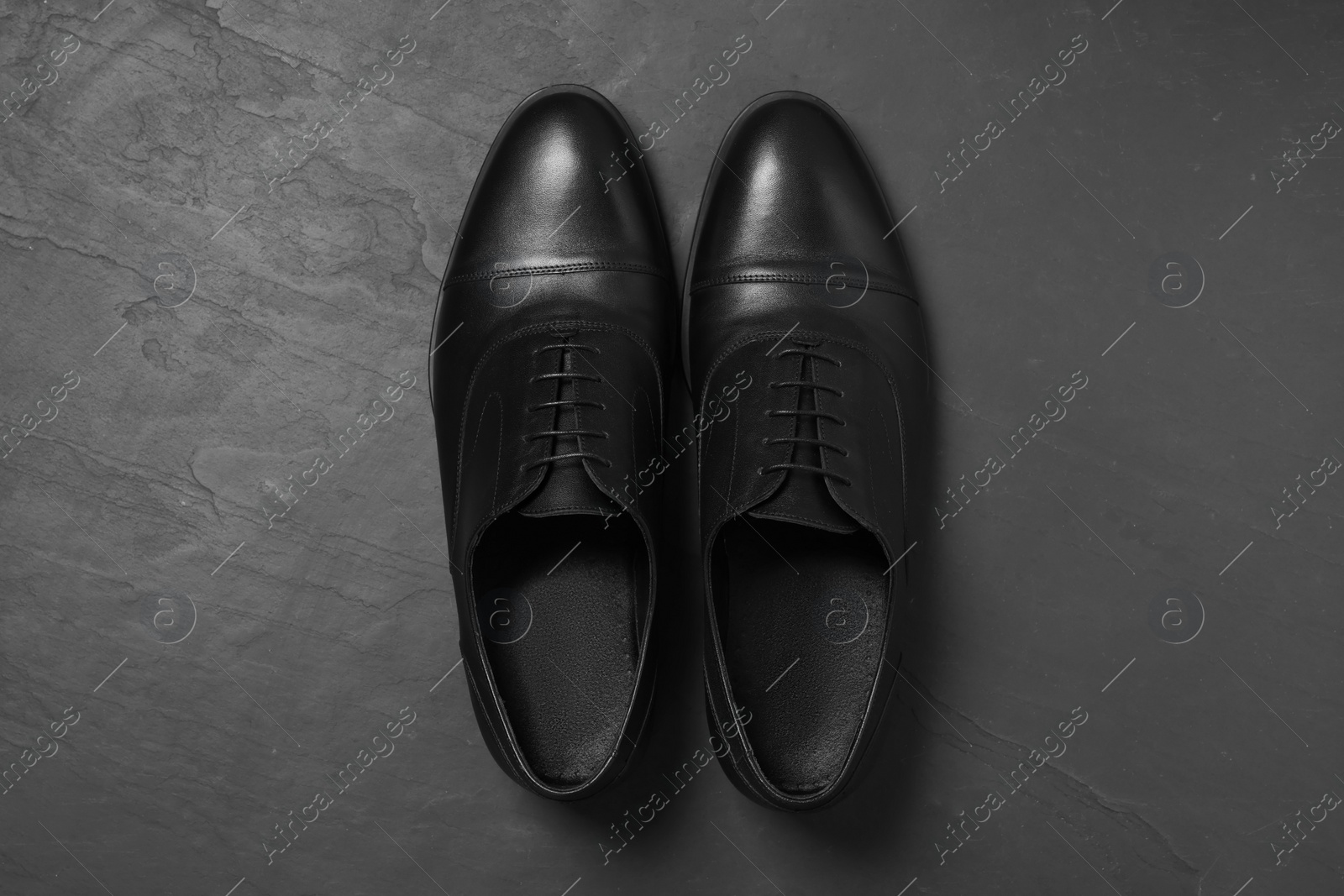 Photo of Pair of leather men shoes on grey surface, top view