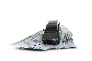 Photo of Miniature automobile model and money on white background. Car buying