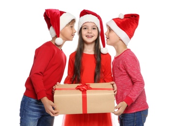 Photo of Cute little children in Santa hats with Christmas gift box on white background