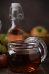 Vinegar in glass jar on wooden table