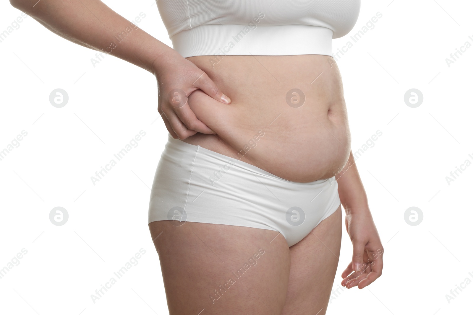 Photo of Woman touching belly fat on white background, closeup. Overweight problem