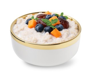 Photo of Delicious barley porridge with blueberries, pumpkin, dates and mint in bowl isolated on white