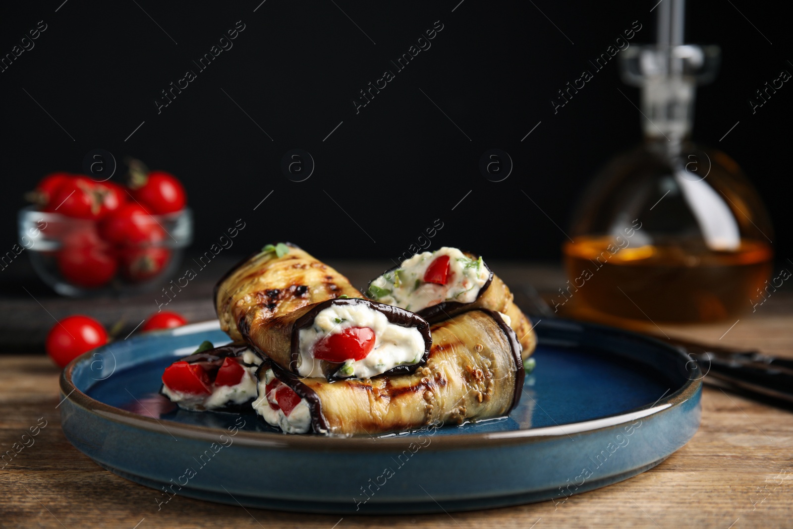 Photo of Delicious baked eggplant rolls served on wooden table