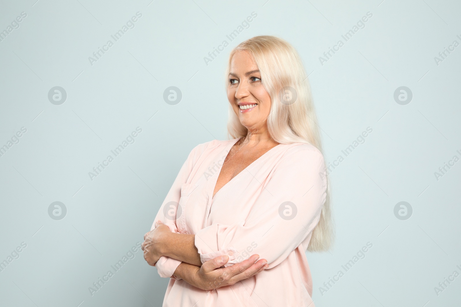 Photo of Portrait of mature woman with beautiful face on grey background