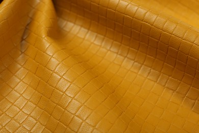 Photo of Beautiful yellow leather as background, closeup view